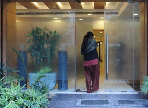 An Indian surrogate mother enters the Surrogacy Centre India (SCI) clinic in New Delhi on February 5, 2013