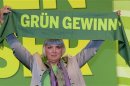 German Green Party co-leader Roth holds a scarf reading: "Green will win" after her re-election at the party convention of the Green Party in Hanover,
