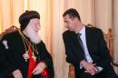 FILE - In this file photo taken Tuesday, Dec. 25, 2007, the Patriarch of the Syriac Orthodox Church Ignatius Zakka Iwas, left, welcomes Syria's President Bashar Assad upon his arrival at St. Aphrem church in Damascus, Syria. Iwas, the leader of one of world's oldest Christian sects, has died. He was 80. (AP Photo, File)