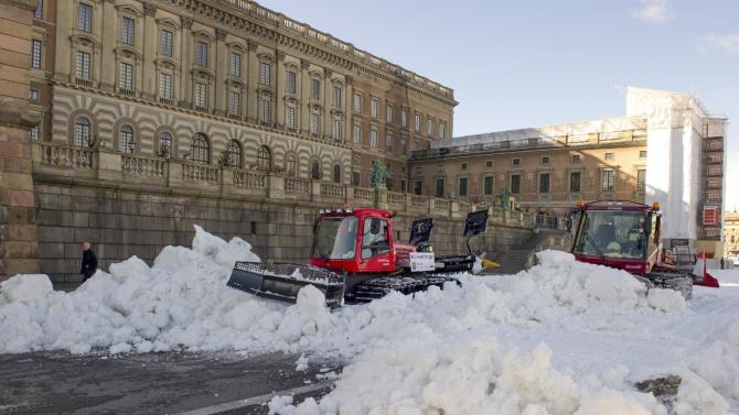 FILE - This is a March 12, 2012 file photo shows snow being moved in preparation prior to the World Cup Cross Countery skiiing sprint competition round the Stockholm Royal Palace. Snowy white winters are likely to become a thing of the past for most Swedes.  The national weather service Monday Nov. 2, 2015 released a new analysis of how climate change will affect the Nordic country _ and it’s bad news for skiing enthusiasts. (AP Photo/Bertil Ericson)  SWEDEN OUT