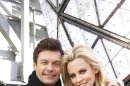 Entertainers Ryan Seacrest, left, and Jenny McCarthy, hosts of Dick Clark's New Year's Rockin' Eve on ABC, pose for a portrait Friday, Dec. 28, 2012 in New York. (Photo by Dan Hallman/Invision/AP Images)