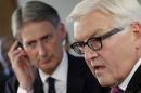 German Foreign Minister Frank-Walter Steinmeier, right, and his counterpart from Britain, Philip Hammond, left, address the media during a joint press conference after a meeting in Berlin, Germany, Thursday, Sept. 11, 2014. (AP Photo/Michael Sohn)