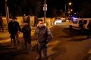 Israeli security personals secure an area in Jerusalem where an Israeli far-right activist was shot and wounded