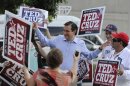 Former Texas Solicitor General Ted Cruz, center, greets supporters at a voting precinct Tuesday, July 31, 2012, in Houston. Cruz faces Lt. Gov. David Dewhurst in the Republican primary runoff election for the Republican nomination for the U.S. Senate. (AP Photo/Pat Sullivan)