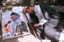 FILE-In this Tuesday, August 8, 2000 file photo, Iranian clergyman Mohammad Azadparvar, who allegedly was injured by chemical weapons in the 1980-88 Iran-Iraq war, rests next to a picture of the supreme leader Ayatollah Ali Khamenei, at a demonstration in front of Iranian parliament in support of the supreme leader Ayatollah Ali Khamenei. For more than a generation, Iranian newspapers regularly post notices: Another veteran of the 1980s' war with Iraq has died of complications from exposure to chemical weapons from Saddam Hussein's arsenal. The claims now that Iran's Syrian allies used similar battlefield tactics, including possibly unleashing sarin gas, forced Tehran's leaders into perhaps their most difficult juncture of the nearly 30-month Syrian civil war: How much to stick by Bashar Assad if the Western allegations are backed by U.N. inspection teams. (AP photo/Vahid Salemi)