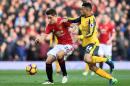 Manchester United's Spanish midfielder Ander Herrera (L) vies with Arsenal's French midfielder Francis Coquelin during the English Premier League football match between Manchester United and Arsenal on November 19, 2016