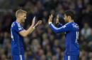 Chelsea's Diego Costa, right, celebrates with teammate Andre Schurrle after scoring against Burnley during their English Premier League soccer match at Turf Moor Stadium, Burnley, England, Monday Aug. 18, 2014. (AP Photo/Jon Super)