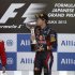 Red Bull Formula One driver Vettel kisses his trophy on podium next to second placed Ferrari Formula One driver Massa and thrid placed Sauber Formula One driver Kobayashi after Japanese F1 Grand Prix at Suzuka circuit