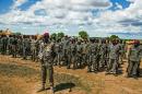The Sudan People's Liberation Army (SPLA) soldiers stand at attention at a containment site outside Juba on April 14, 2016