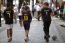 Tres niños con camisetas de fútbol caminan por la calle de Main Street en Gibraltar (Reino Unido). EFE