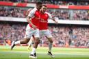 Arsenal's Chilean striker Alexis Sanchez (R) celebrates with Arsenal's Nigerian striker Alex Iwobi after scoring during the English Premier League football match against Watford at the Emirates Stadium in London on April 2, 2016