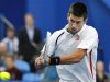 Djokovic of Serbia hits a return to Haas of Germany during their men's singles match at the Hopman Cup tennis tournament in Perth
