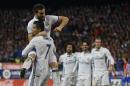 Real Madrid's Cristiano Ronaldo, bottom left, celebrates with teammate Jose Luis Fernandez "Nacho", top, after scoring their side's third goal against Atletico Madrid during a Spanish La Liga soccer match between Real Madrid and Atletico Madrid at the Vicente Calderon stadium in Madrid, Saturday, Nov. 19, 2016. Ronaldo scored a hat trick in Real Madrid 3-0 victory. (AP Photo/Francisco Seco)