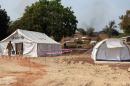 Two tents to treat potential Ebola virus patients are set up on November 17, 2014 in the village of Kouremale, Mali, near the border with Guinea