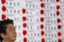 Japan's PM Abe, and the leader of the ruling LDP, listens to a question at the party headquarters in Tokyo