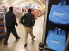 Workers walk through a new Wal-Mart store in Chicago
