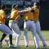 Oakland Athletics' Nate Freiman is congratulated by teammates after hitting the game-winning single during their MLB game against the New York Yankees in Oakland