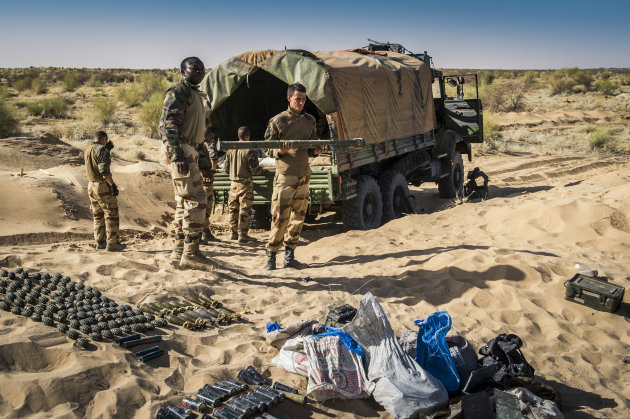 In this March 29, 2013 photo provided by the French Army's images division, ECPAD, a French soldier holds the launch tube of an SA-7 surface-to-air missile before its destruction in Timbuktu, northern Mali. The knowledge that the terrorists have the weapon has already changed the way the French are carrying out their five-month-old offensive in Mali. They are using more fighter jets rather than helicopters to fly above its range of 1.4 miles (2.3 kilometers) from the ground, even though that makes it harder to attack the jihadists. They are also making cargo planes land and take off more steeply to limit how long they are exposed, in line with similar practices in Iraq after an SA-14 hit the wing of a DHL cargo plane in 2003. (AP Photo/ECPAD, Olivier Debes)
