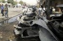 Iraqi security personnel inspect the site of a bomb attack in Baghdad