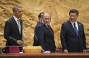 U.S. President Barack Obama, left, Chinese President Xi Jinping, right, and Russian President Vladimir Putin, center, arrive at the the Asia-Pacific Economic Cooperation (APEC) Summit plenary session at the International Convention Center, Yanqi, Tuesday, Nov. 11, 2014 in Beijing. (AP Photo/Pablo Martinez Monsivais, Pool)