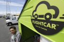In this photo taken Tuesday, June 11, 2013 Flightcar CEO Rujul Zaparde, poses outside a small rental shack on their lot in Burlingame, Calif. A San Francisco Bay area startup company founded by three teenage Ivy League dropouts is trying to change the airport car rental business. FlightCar rents out people's personal vehicles while they are traveling, giving them a share of the proceeds and free airport parking in exchange. But the company's rosy outlook does have some thorns. San Francisco's City Attorney has sued FlightCar, accusing it of unfair competition. (AP Photo/Eric Risberg)