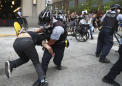Squad cars damaged, protesters struck with batons in Chicago