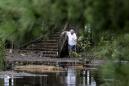 The Latest: Child swept away by floodwaters