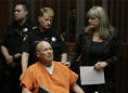 The Latest: Suspect in serial killings isn't in wheelchair