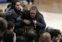 The Latest: Hundreds gather for school shooting vigil