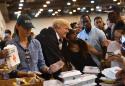 Trump visits evacuees at shelter in storm-battered Houston