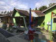 The Latest: Indonesia tsunami swept away houses