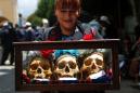 Bolivians decorate skulls with sunglasses and cigarettes to honor the dead