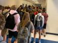 The Georgia school that punished students for posting photos of a packed hallway says it will close for 2 days after multiple students and staff got COVID-19