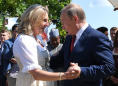 Cossacks and flowers as Putin dances at Austrian minister's wedding