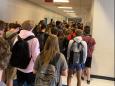 Photos of mask-less students crammed into a Georgia school hallway show how difficult reopenings could be