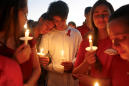 The Latest: Hundreds at vigil mourn school shooting victims