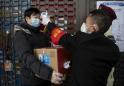 Virus death toll surges as China changes way it counts cases