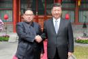 N. Korea's Kim shows unity with China's Xi in first foreign trip