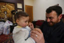 Syrian father teaches daughter to laugh when the bombs fall