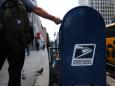 A USPS worker suspected of throwing away bags full of mail posted about the QAnon conspiracy theory
