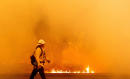 At least 2 people fighting California's raging fires die as thousands flee homes