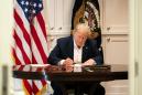 Trump mocked for signing apparently blank paper in 'staged' photos at Walter Reed