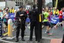 Police launch new raids as Manchester runners defy terror threat
