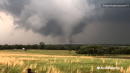 Onlookers film tornado in field