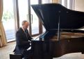 Putin blames off-key piano for hesitant musical rendition
