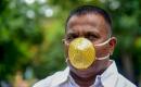 Indian man wears gold face mask to ward off coronavirus