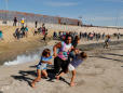 The Story Behind the Photo of a Family Running From Tear Gas at the U.S.-Mexico Border