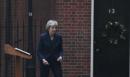 UK's May survives, weakened and with an exit date