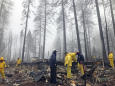 Rain tamps down California fire but turns grim search soggy